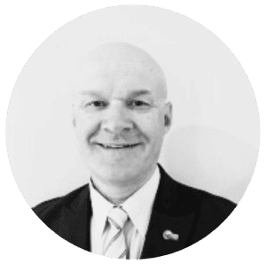 A man in a suit and tie smiling.